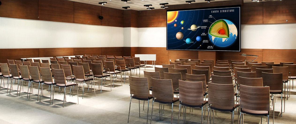 a hall with many chairs and monitor