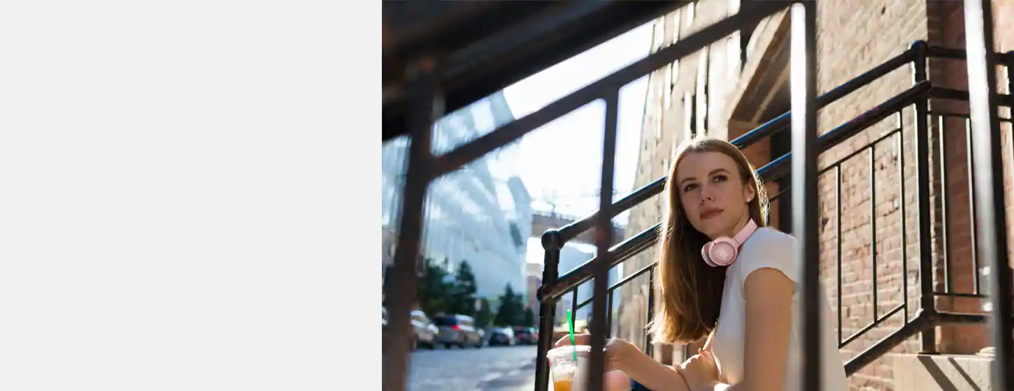 A girl wears JBL TUNE 500BT Wireless on-ear headphones