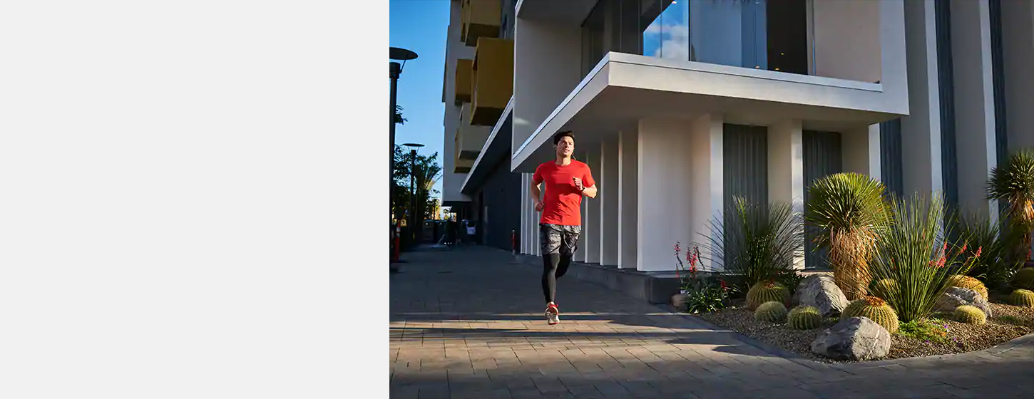 A boy wears JBL REFLECT MINI 2 Lightweight Wireless Sport Headphones