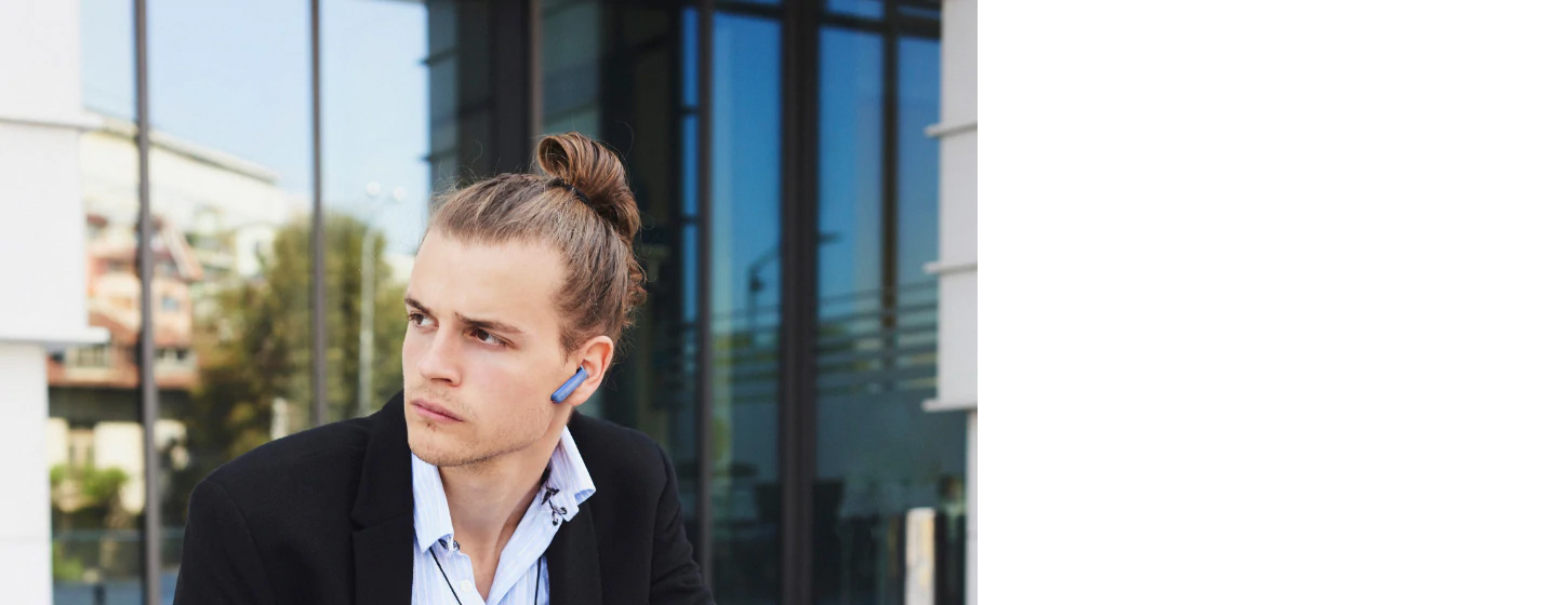 A man wears JBL TUNE 220TWS True wireless earbuds