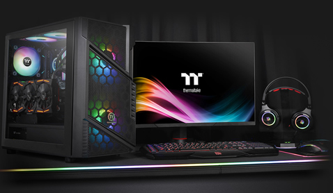 Thermaltake Commander C31 Case Fully Loaded with components next to a gaming monitor, keyboard, headphones and mouse