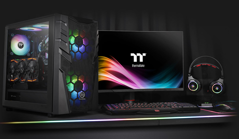 Thermaltake Commander C32 Case Fully Loaded with components next to a gaming monitor, keyboard, headphones and mouse