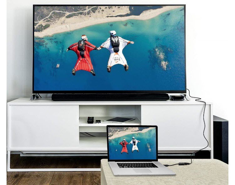 a laptop connects to a TV via the adapter to play a video
