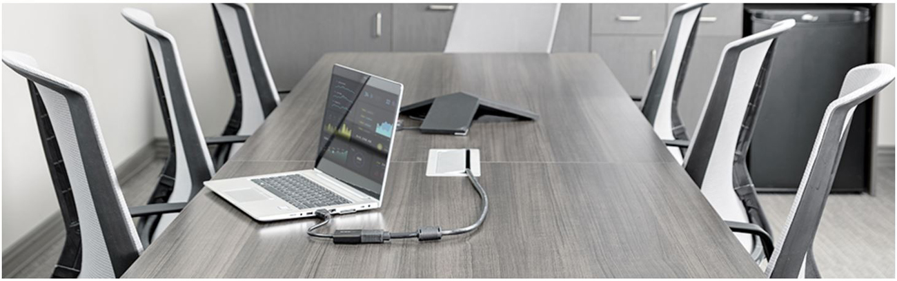 An HDMI laptop is connected to a VGA display via the adpater in a meeting room