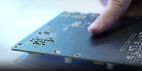 Closeup of a finger pointing at the back of the graphics card board