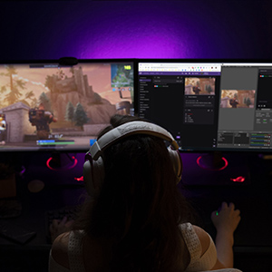 a girl streaming games via two monitors