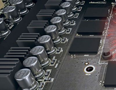 Top view of power delivery zone of this graphics card, showing capacitors, chokes and more