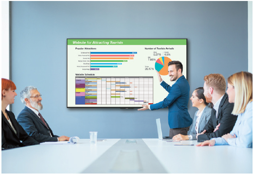 A meeting-room presentation where a male worker is utilizing the mounted Sharp display