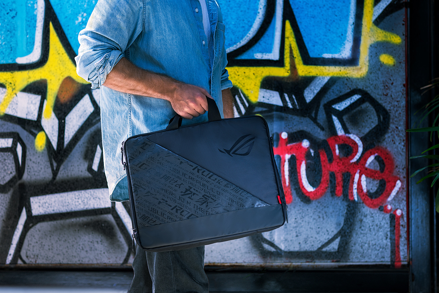 A man is carraying with ROG case.