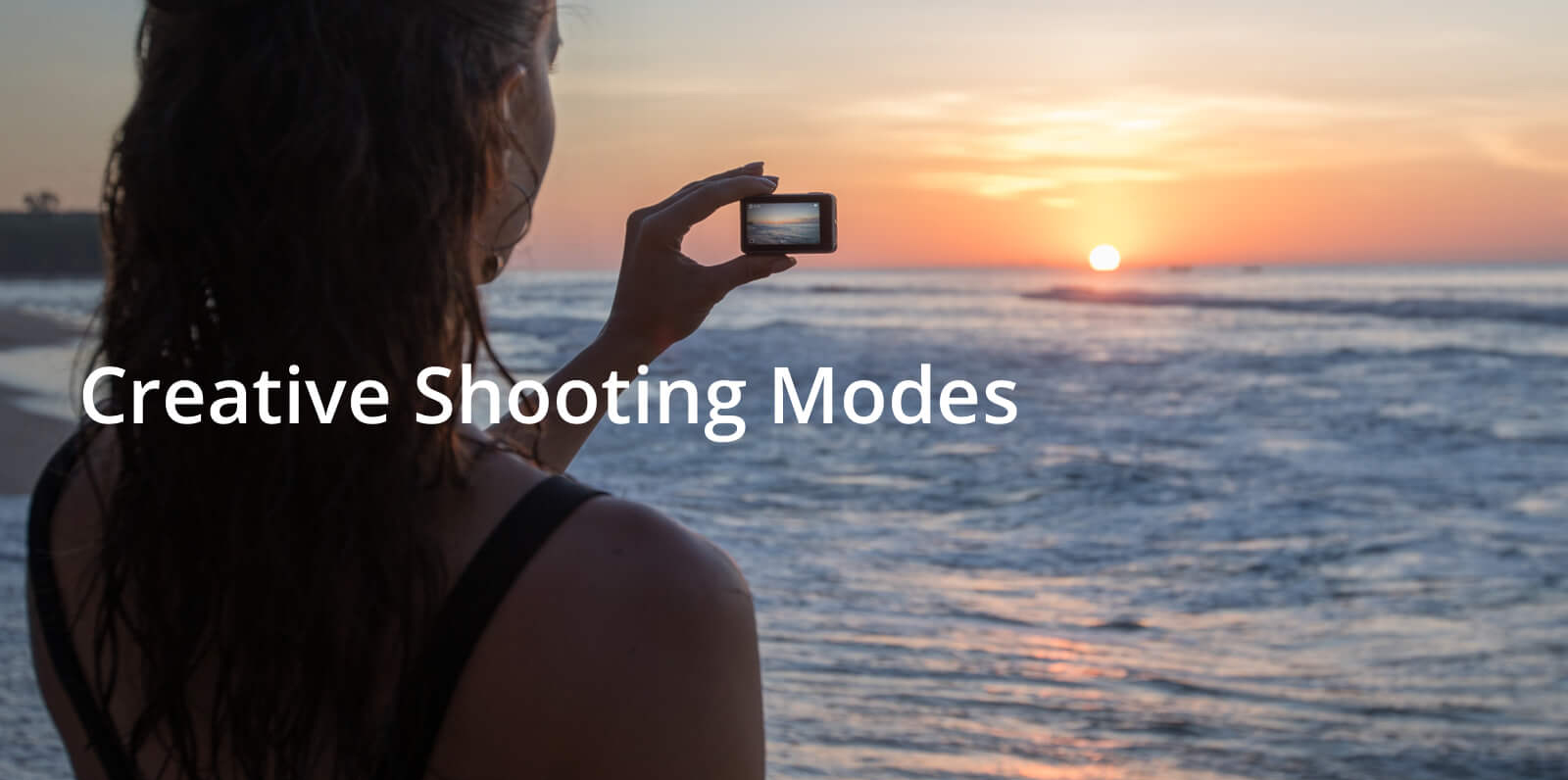 A young woman taking a selfie with the Osmo Action during sunset at the beach. Text in front reads: Creative Shooting Modes
