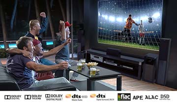 A Group Cheering Towards Their Living Room TV That Shows a Soccer Game