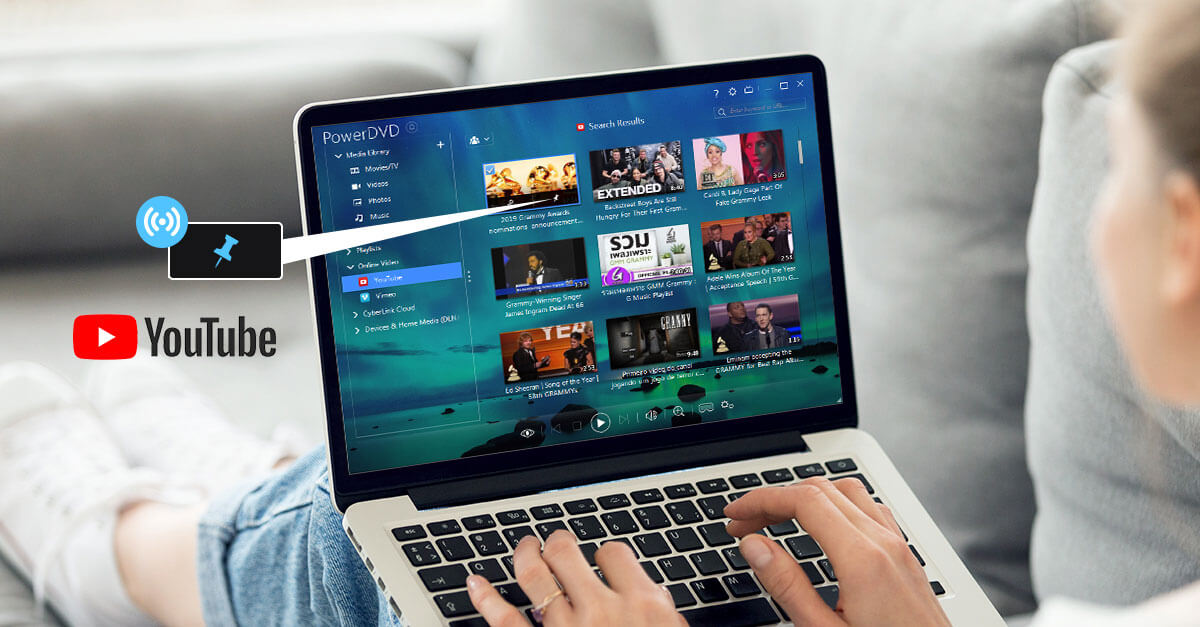A Woman Using an Open Laptop with PowerDVD Software Open, the YouTube logo is next to the laptop