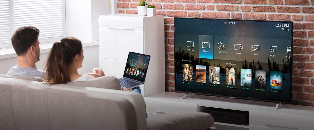 A couple is casting content from a laptop to a TV