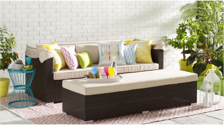 An outdoor area equipped with sofa, desk and side table
