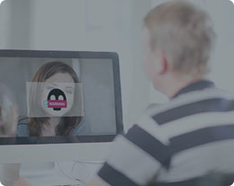 A man video conferencing with a woman and a virus pop-up comes in front