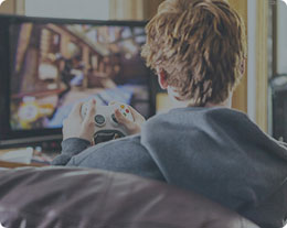 A man gaming with a controller in front of a TV
