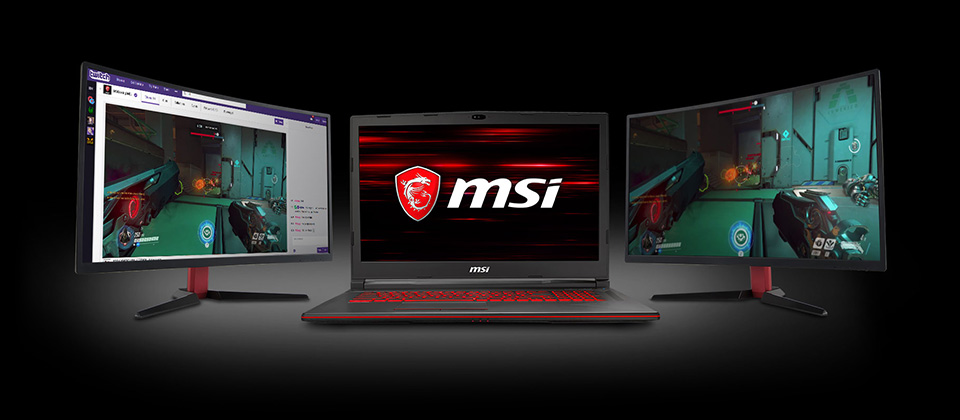 Gigabyte GL73 Gaming Laptop Facing Forward with the MSI Logo on Screen. To each side of the laptop are monitors, showing a twitch stream of Overwatch gameplay and the actual Overwatch gameplay