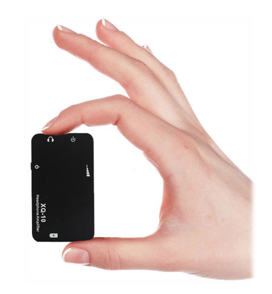 A hand holding a black XQ-10 between its thumb and index finger