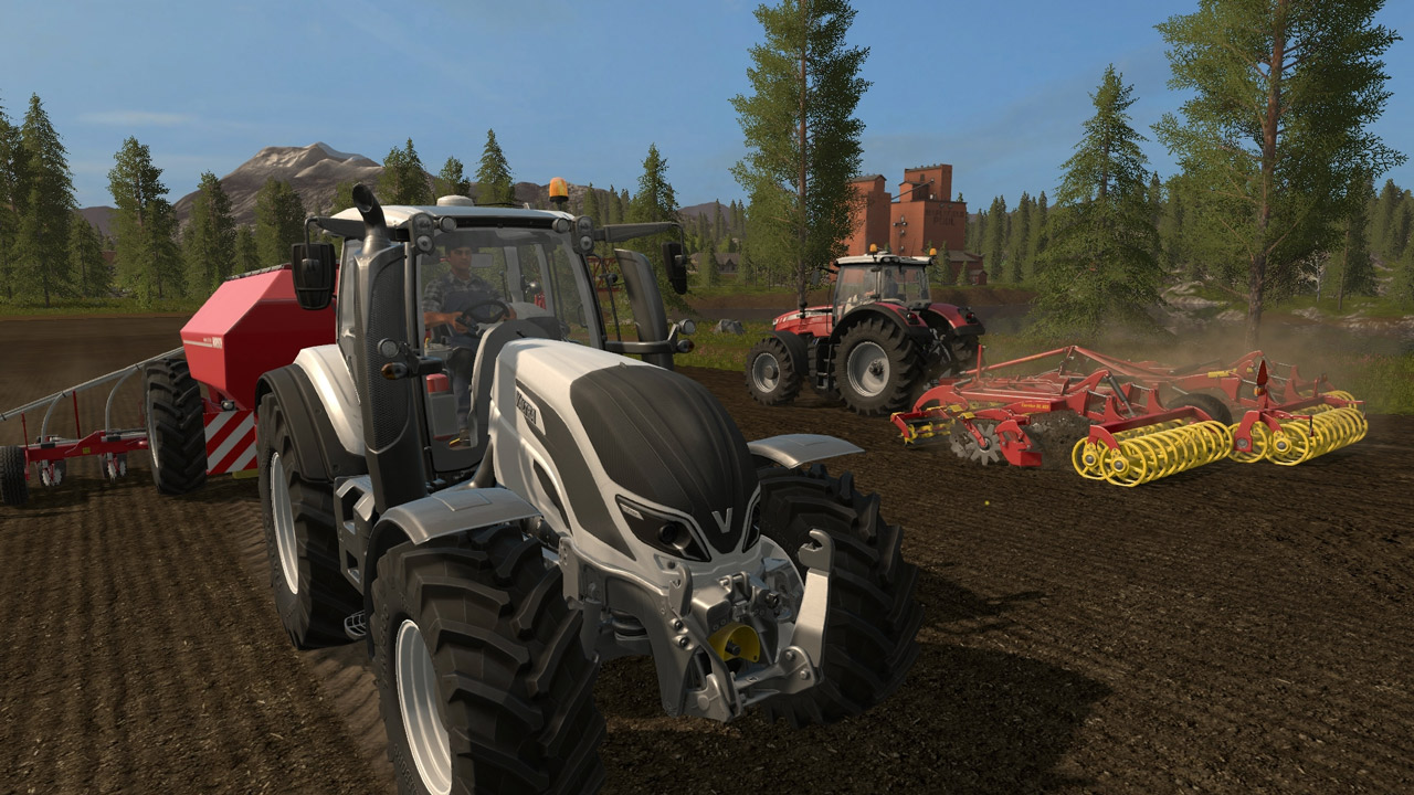 Heavy-duty tractors pullin cultivators over a field of soil