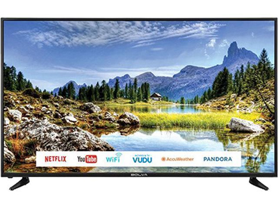 The Bolva 65SVL01 TV facing forward showing a national park during the day time with mountains, water, and grassy rocks