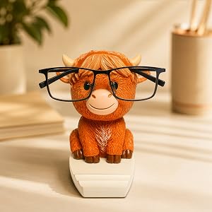 Highland cow glasses holder with eyeglasses resting on cow face