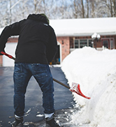 man shoveling snow gloves