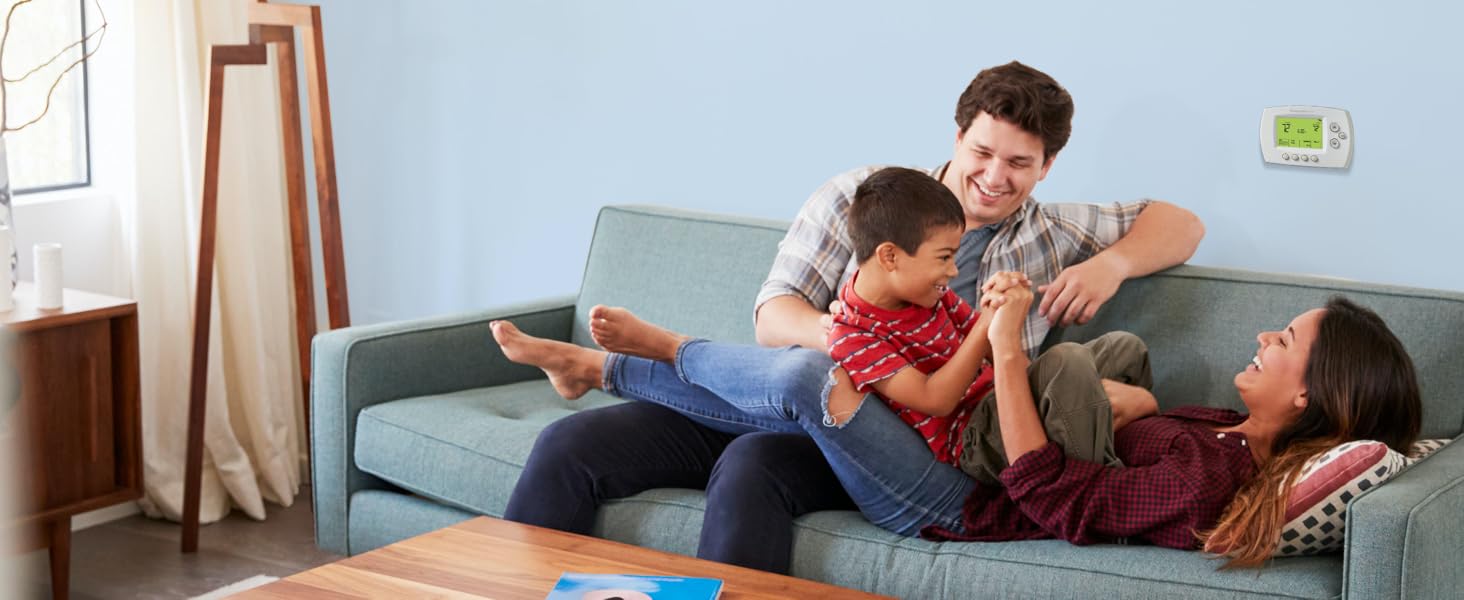 Family playing in front of Wi-Fi 7-Day Programmable Thermostat