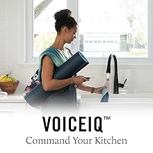 Image of a woman putting her water bottle under the faucet with water on