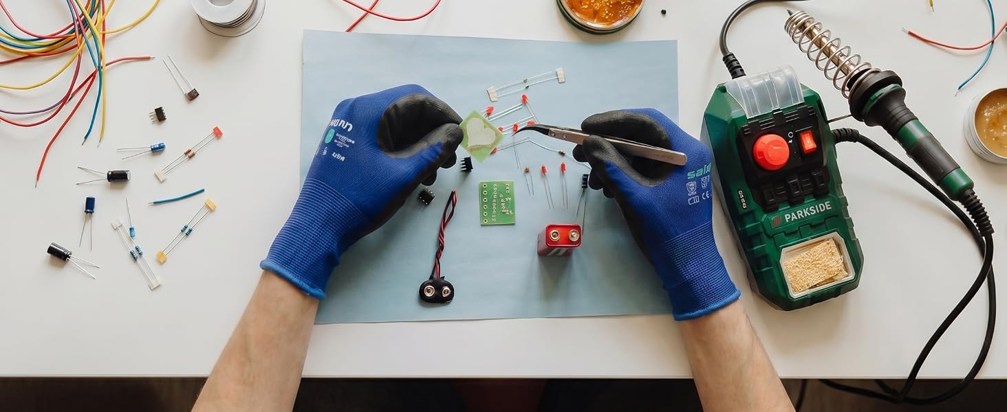 Blue precision work gloves for delicate electronics assembly and soldering tasks.