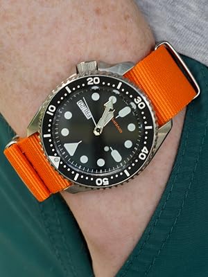 Orange Nylon Watch Band on Black Dive Watch on Wrist with Hand In Pocket