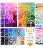 Colorful bead assortment in plastic organizer trays. Various sizes and types including round, faceted, and transparent beads in multiple colors. Includes small golden spacer beads and threading cord.