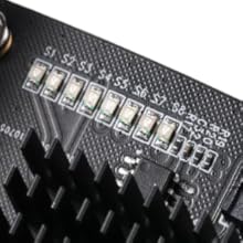 Close-up black and white image of electronic circuit board components showing detailed pattern of electronic pathways.