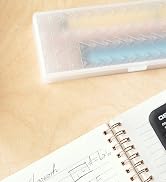 a notebook, pencil, and ruler on a wooden table.