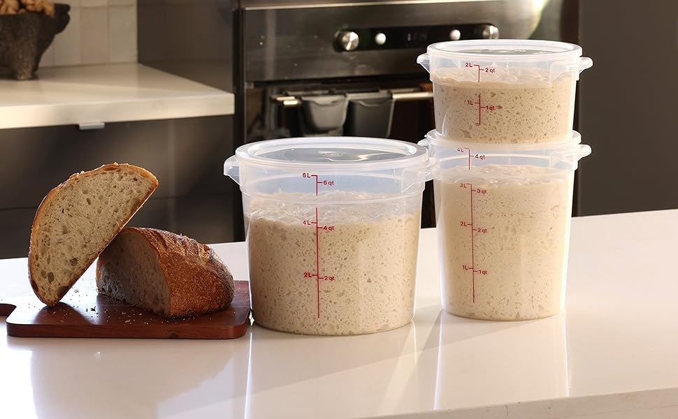 Three translucent dough buckets with lids, next to a sourdough loaf