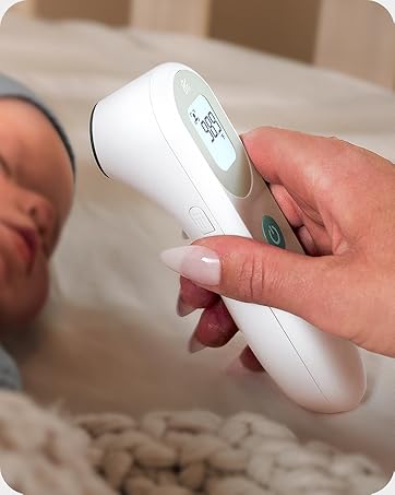Infrared No-Touch Thermometer reading child's temperature in crib