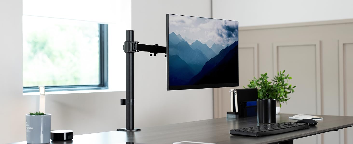 Singe monitor mount clamped to desktop with ultrawide screen