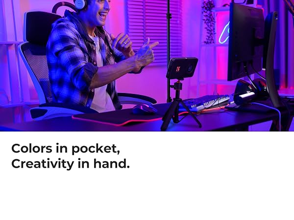 Text reads 'Colors in pocket, Creativity in hand.' Multiple monitors display digital content in a purple-lit workspace setting with computer peripherals visible.