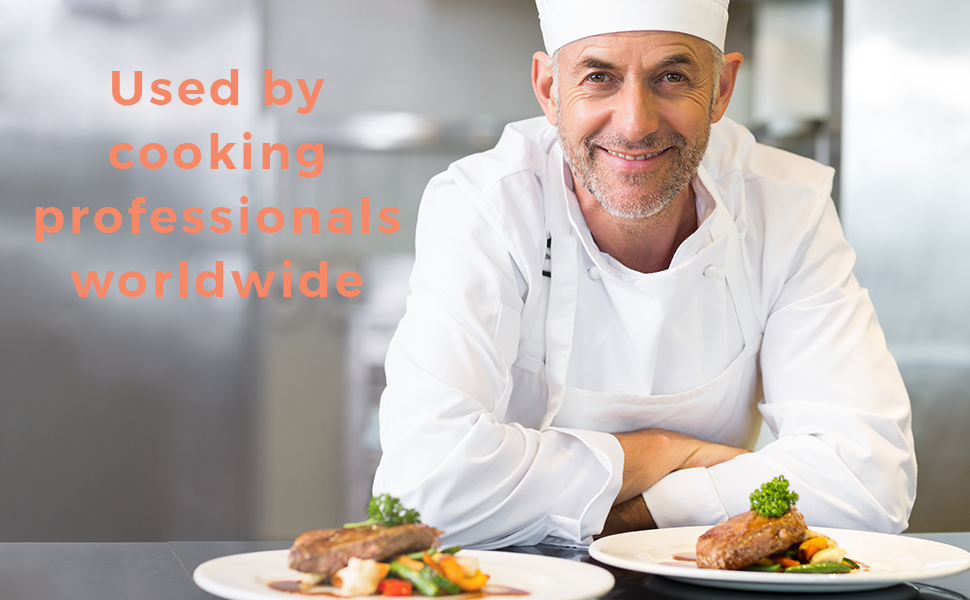 smiling chef with cooked foods at the table