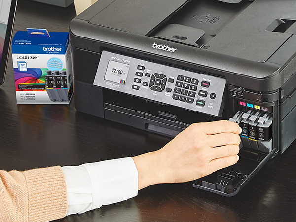 Person installing new LC401 ink cartridges into Brother printer