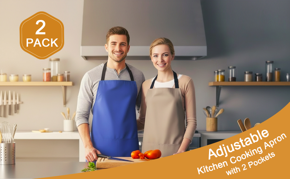 A happy couple in the kitchen, each wearing a cute apron for men and women, smiling at the camera.