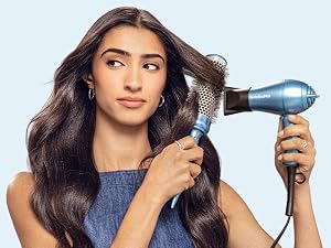 Woman using hair dryer