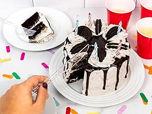 Plastic knife cutting into a birthday cake.