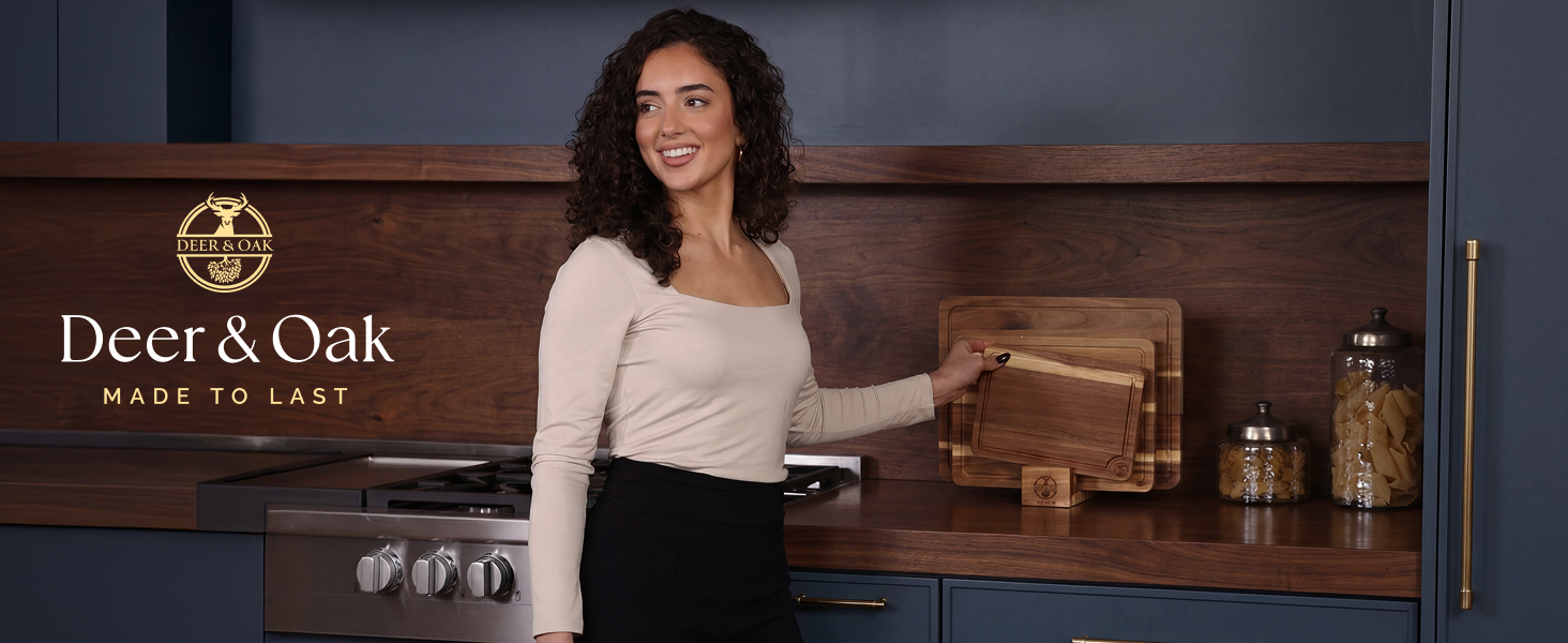 Woman holding wooden cutting boards in modern kitchen.