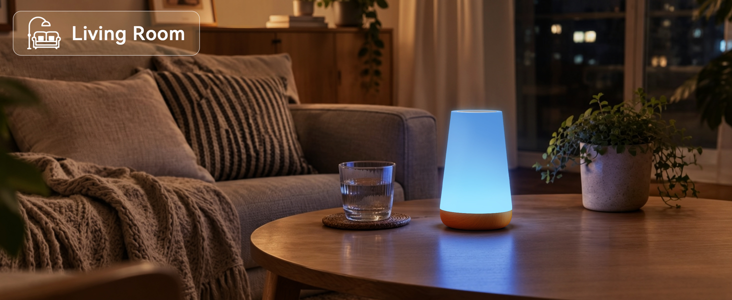 Color changing portable night light lamp glowing blue on coffee table in cozy living room
