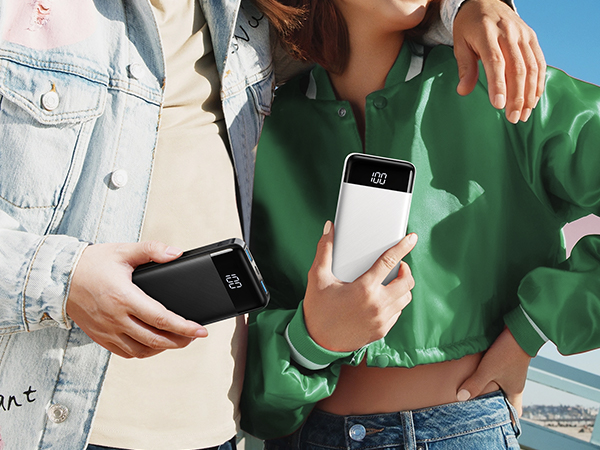 two people holding up their smartphones in a store