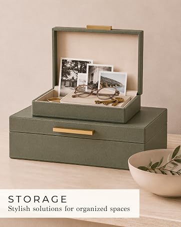 Open green storage boxes holding photos, glasses and keys for stylish organization