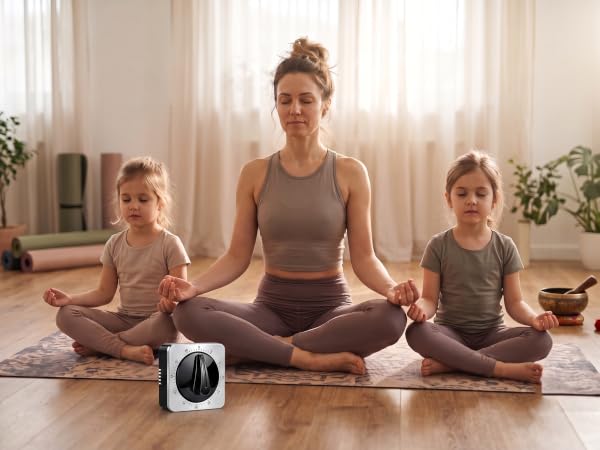 kitchen timer on the floor near a family practicing yoga.