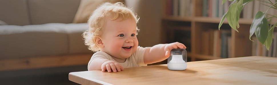 Baby reaching for TranquilTone white noise machine with child lock safety features.
