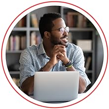 man sitting in front of laptop smiling