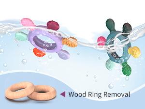 Colorful plastic bath toys shaped like sea creatures floating in water. Two wooden rings labeled 'Wood Ring Removal' sit below, suggesting a bathtub play set for children.